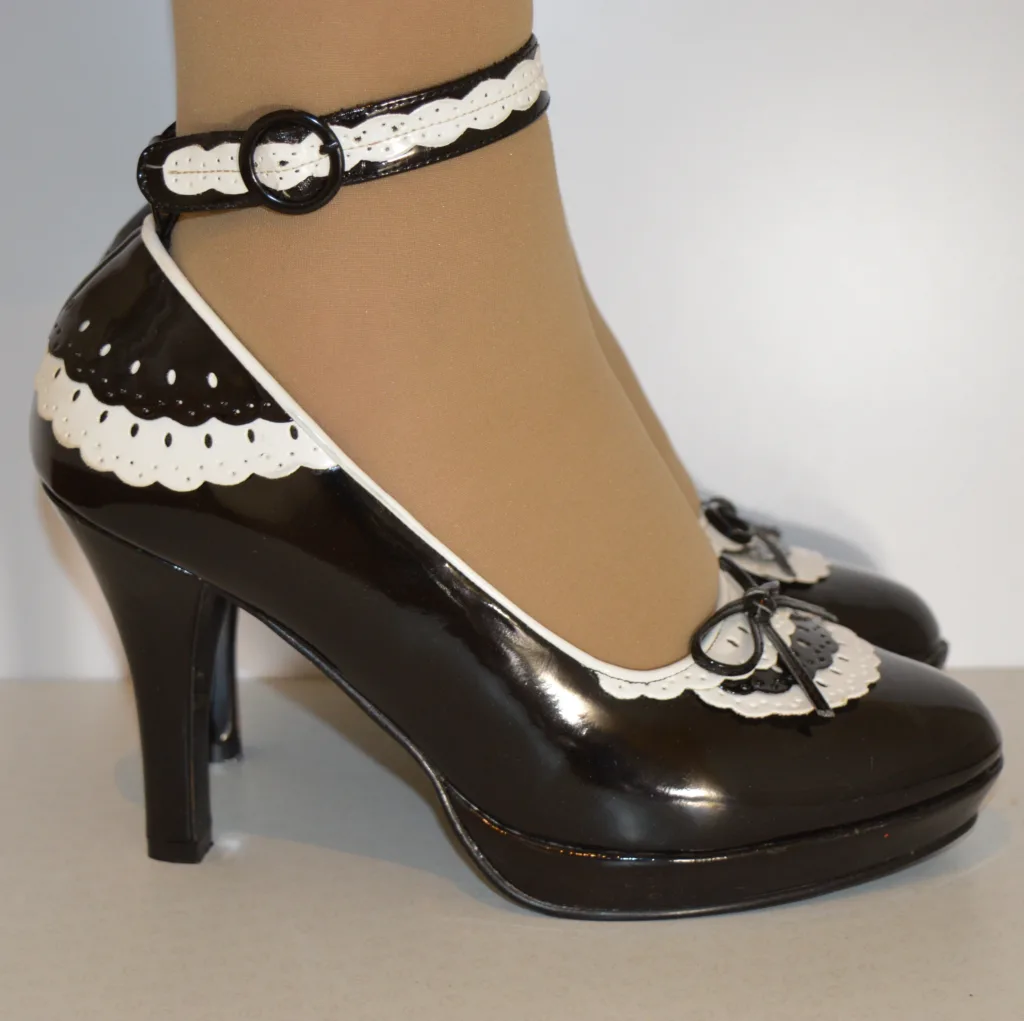 Funtasma (Pleaser) 4 14 inch heels with 3/4 inch platform soles, made of black and white patent leather for French maids.